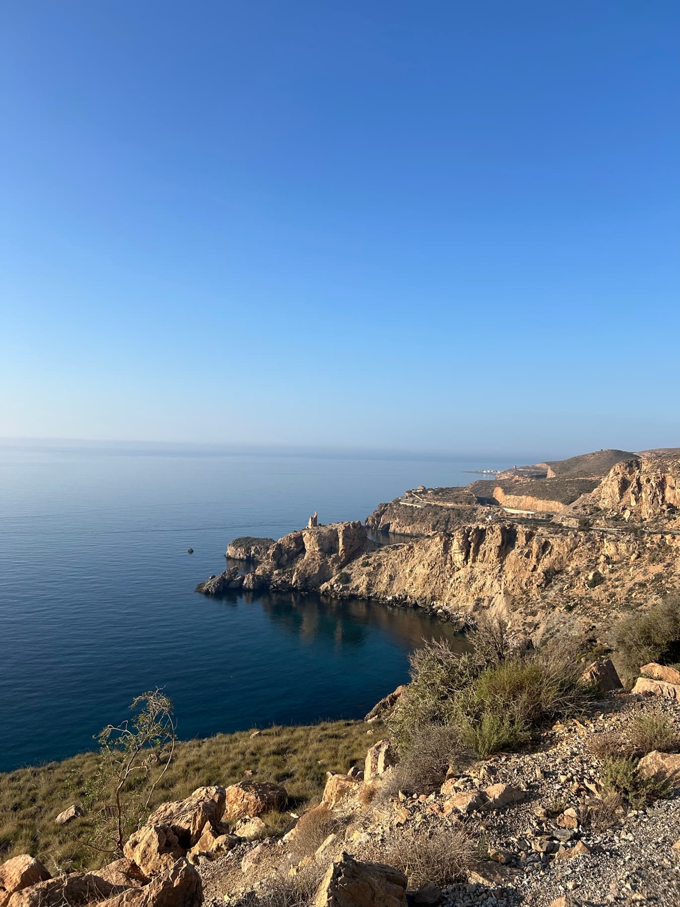 Golden cliff beside a blue sea