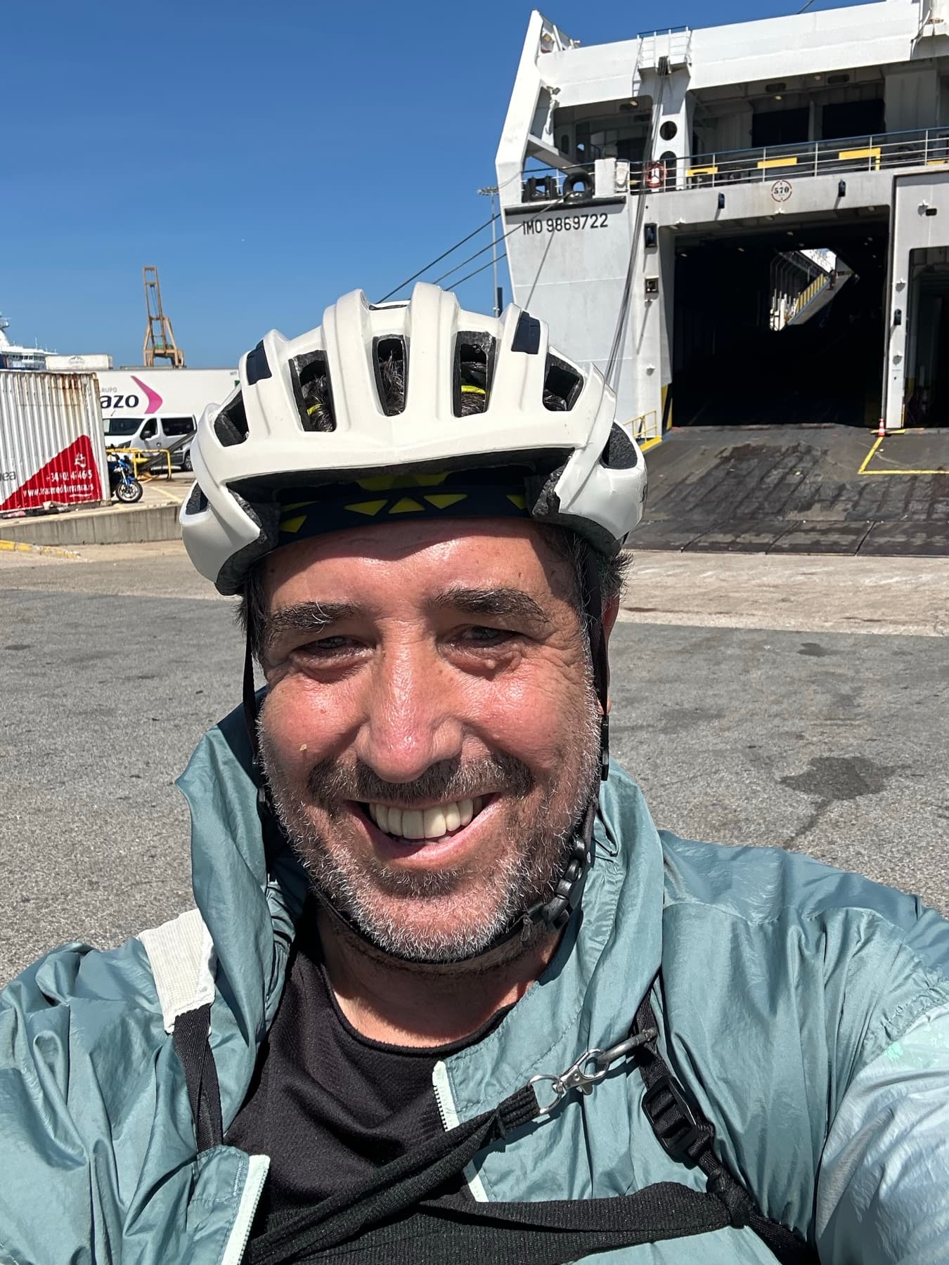 Angel wearing a helmet beside a ferry in port
