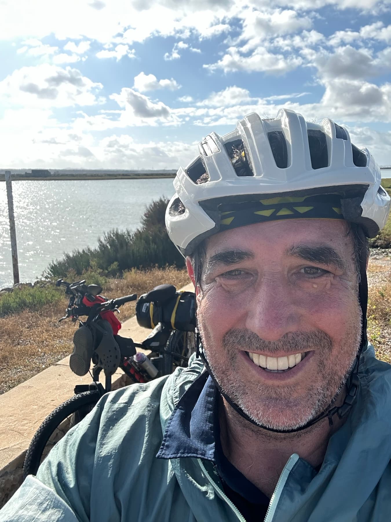 Angel wearing a helmet beside the bicycle in marshland