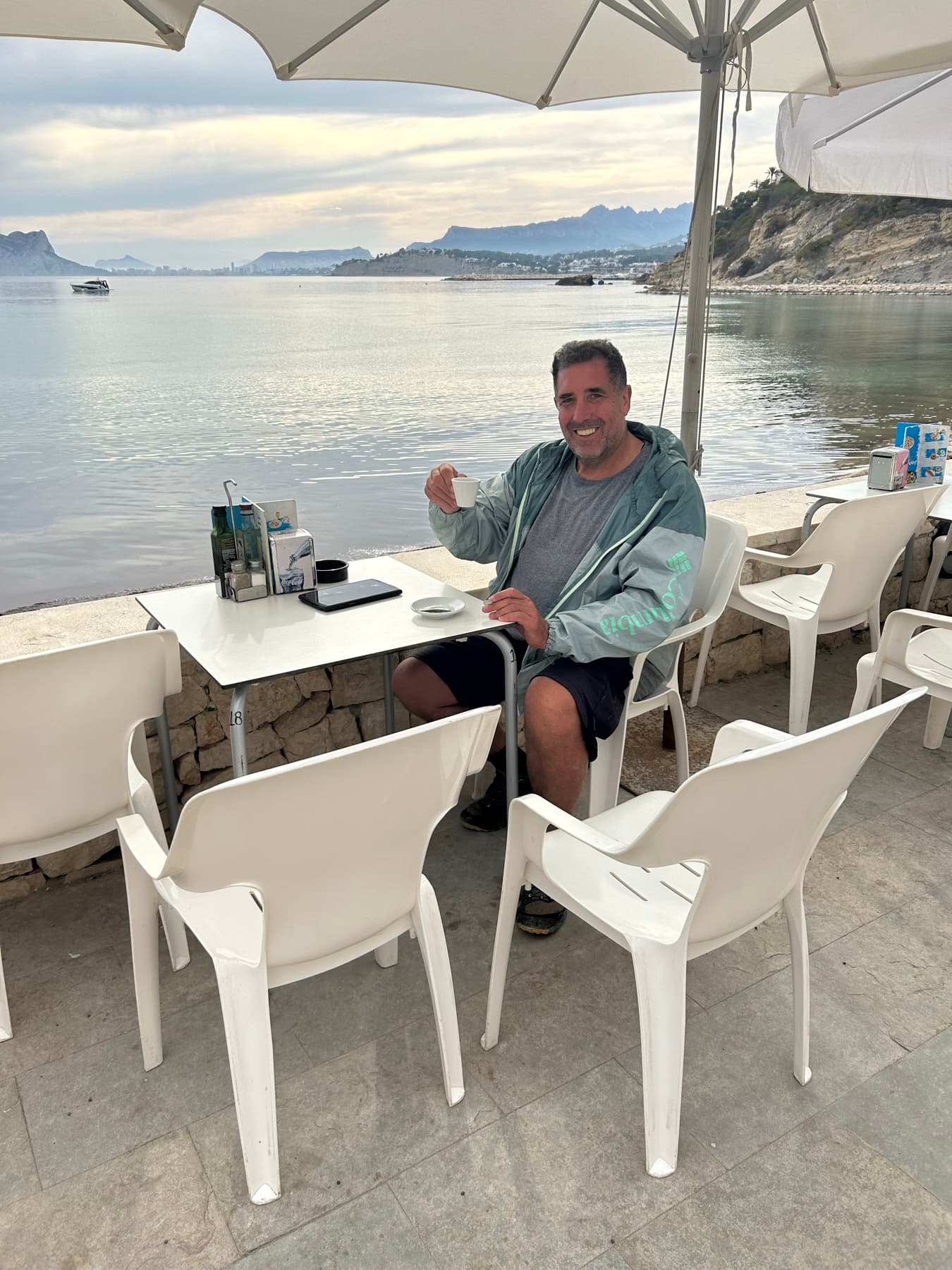 Angel sitting on a terrace by the sea