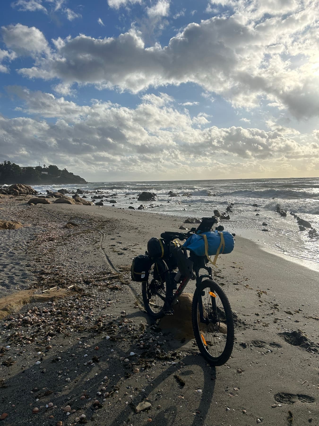 Bicycle facing a beach with surf