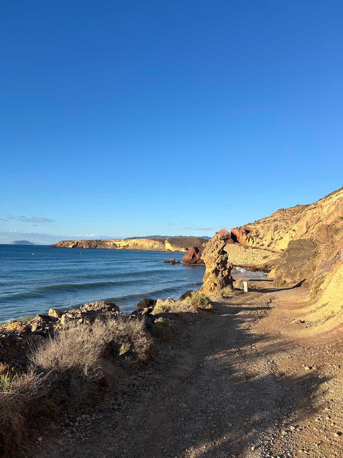 Dirt path beside a coastal cliff