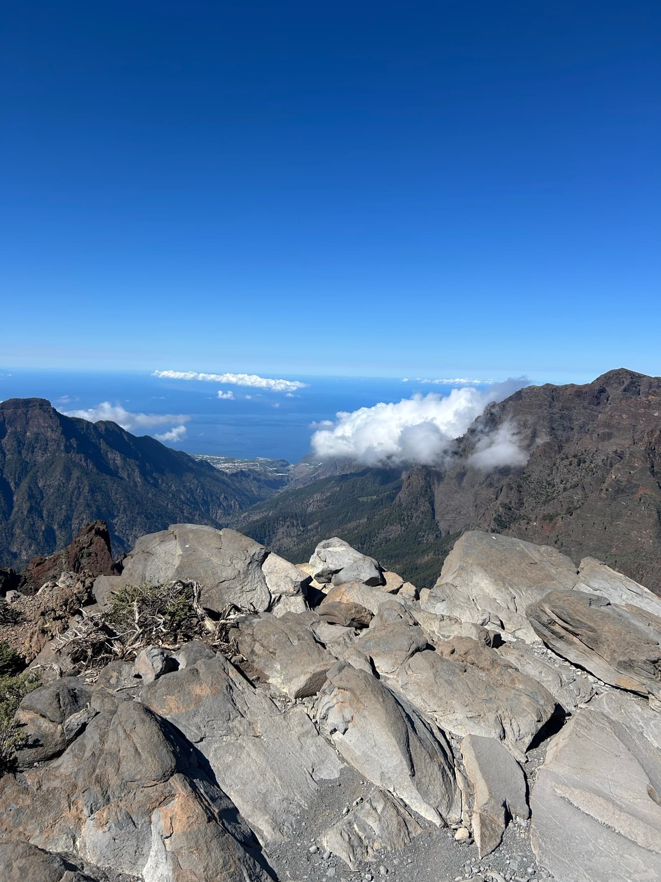 Rocky summit with valley and clouds