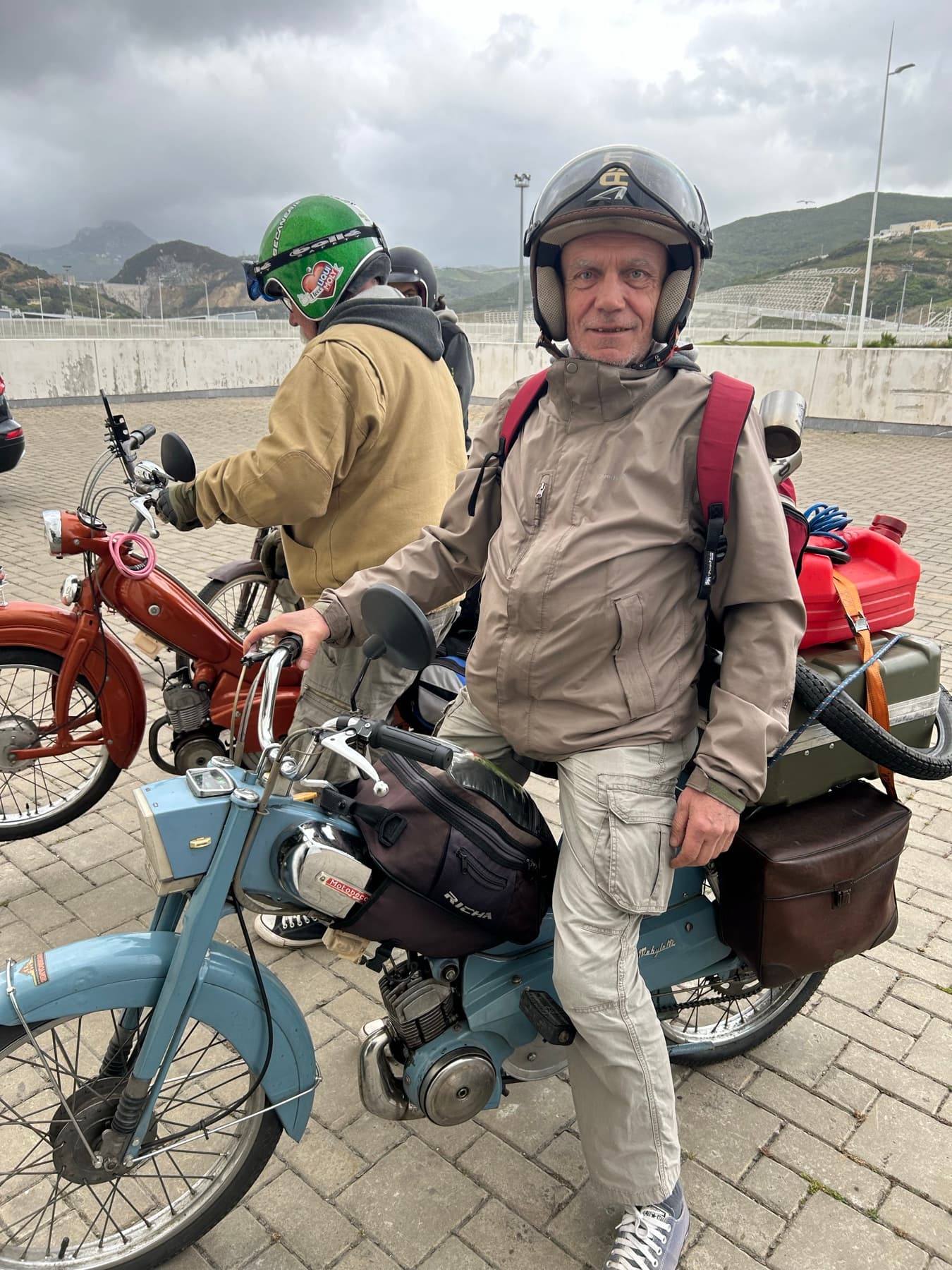 Travelers with classic motorcycles during a stop