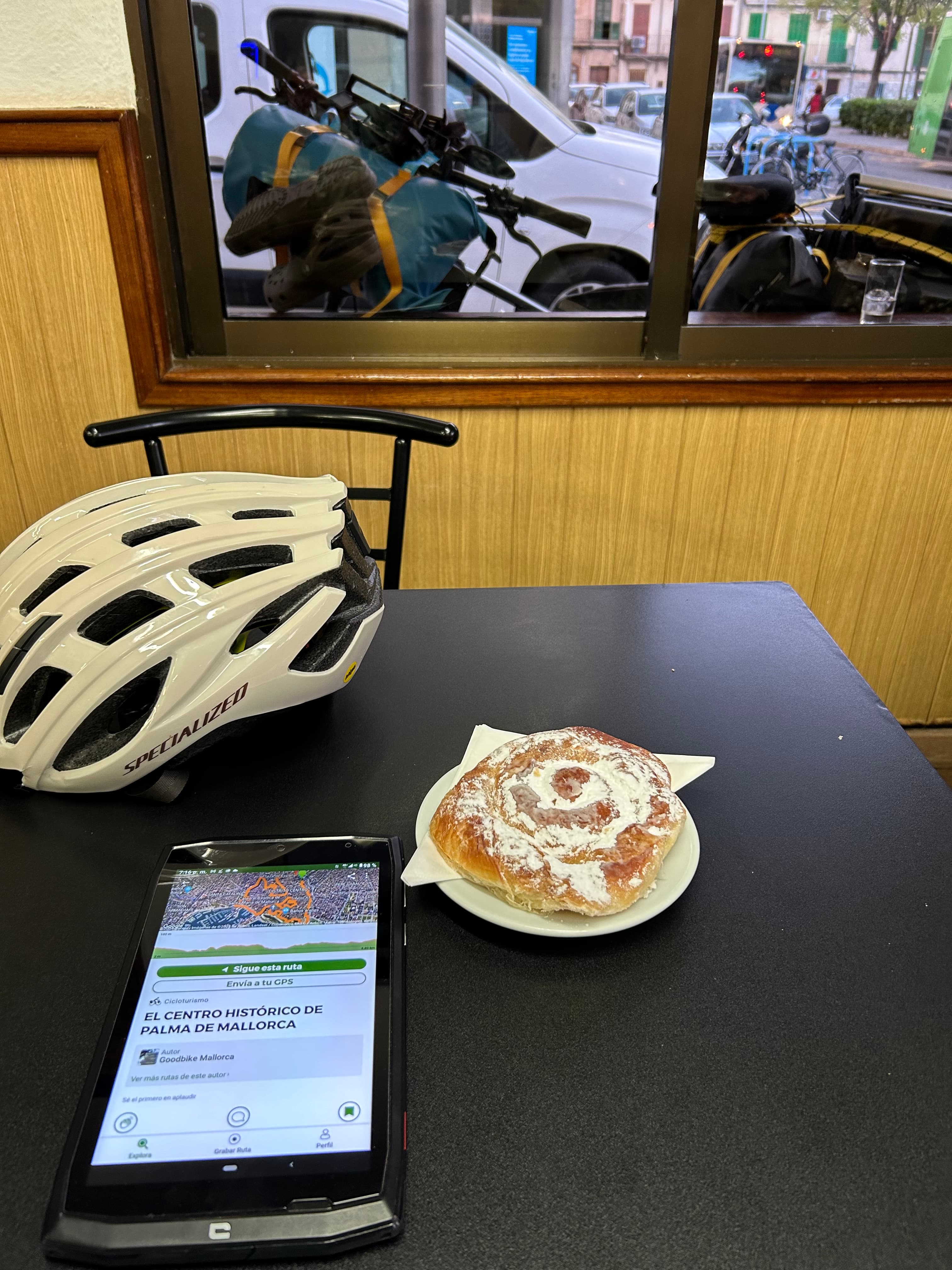 Ensaimada, helmet and route screen on a table