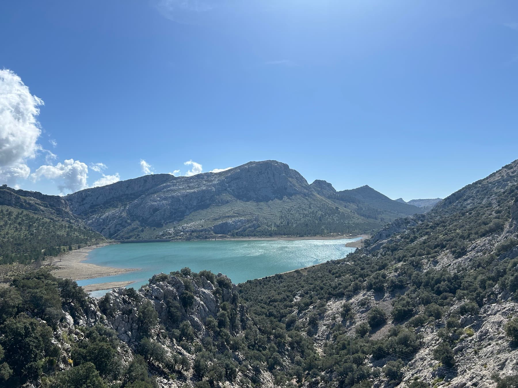 Turquoise cove surrounded by houses and rock