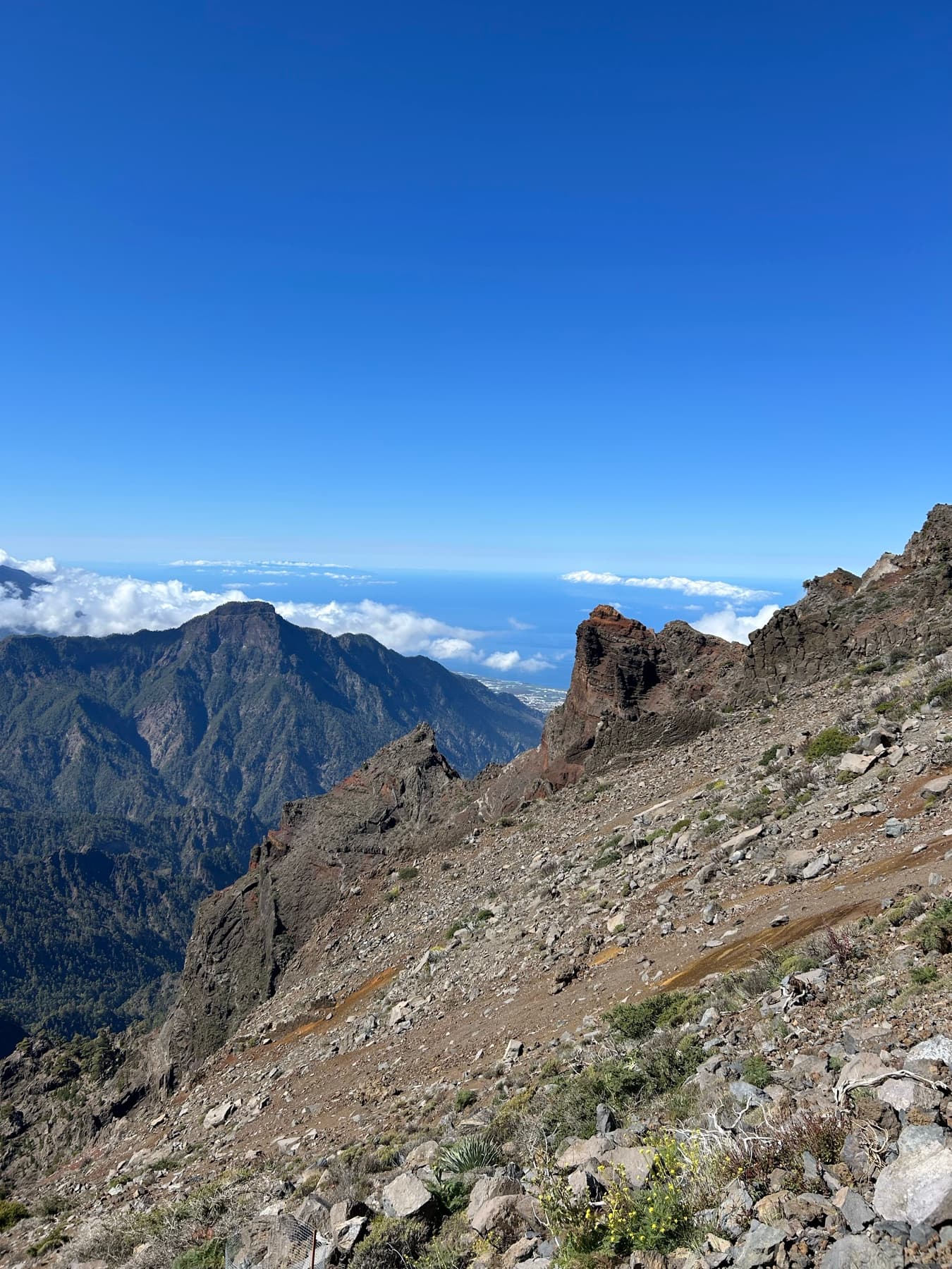 Reddish mountains with the sea in the distance