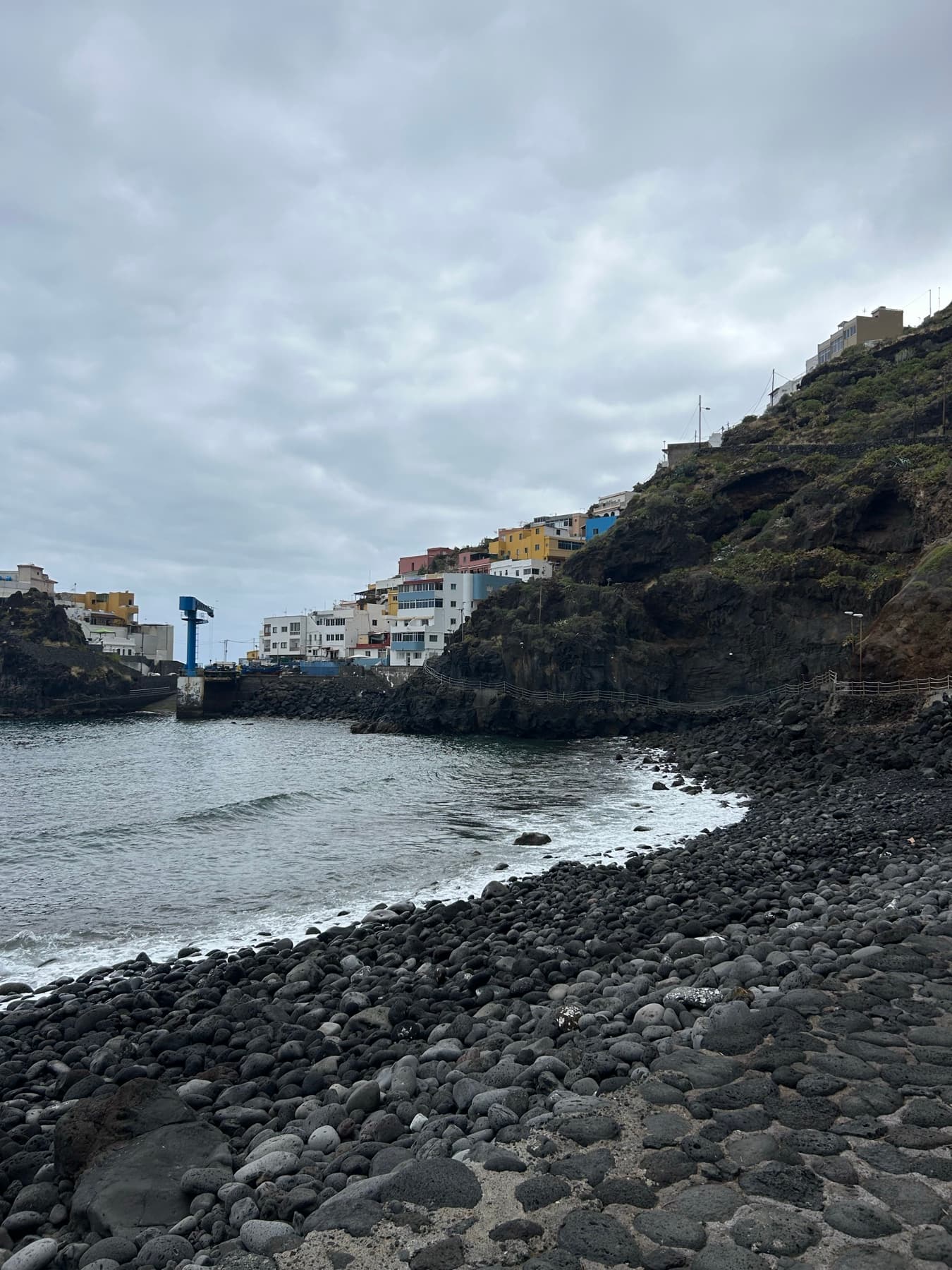 Coastal village between black rock and sea